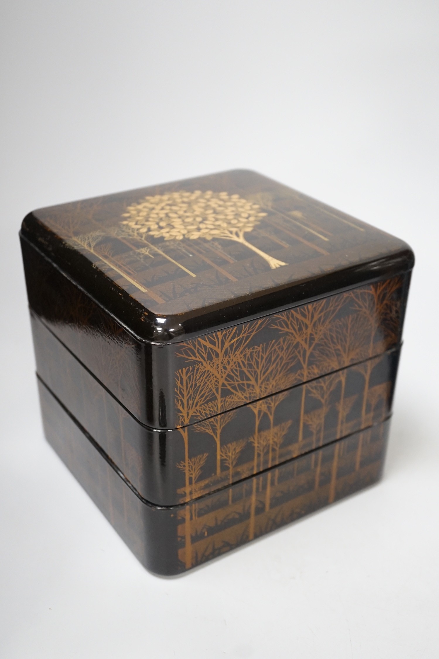 A large Japanese cloisonné enamel vase, 30.5cm high, a similar jar and cover and a Japanese lacquered tiered box with 3-4 drawers. Tree design in gold lacquer.